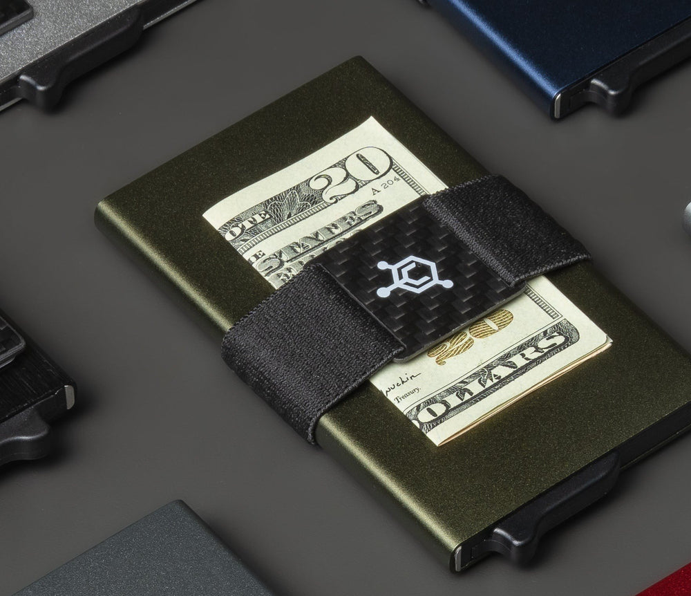 CODE 118 cash strap holding folded twenty dollar bills on an olive wallet