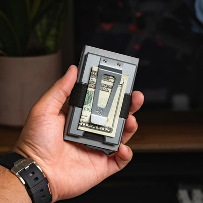 Slim metal money clip wallet holding cash and cards for everyday carry