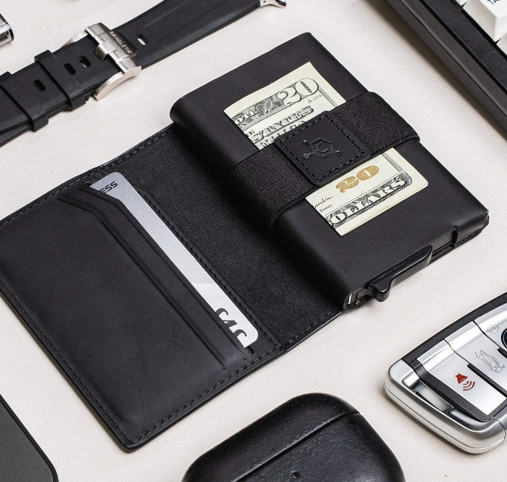 Open black CODE 118 Bi-Fold Leather Case on a desk with a card in its inner pocket and cash under the strap