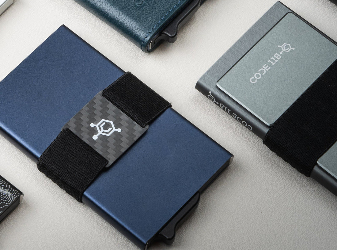 CODE 118 cash strap with carbon fiber logo plate on a navy wallet