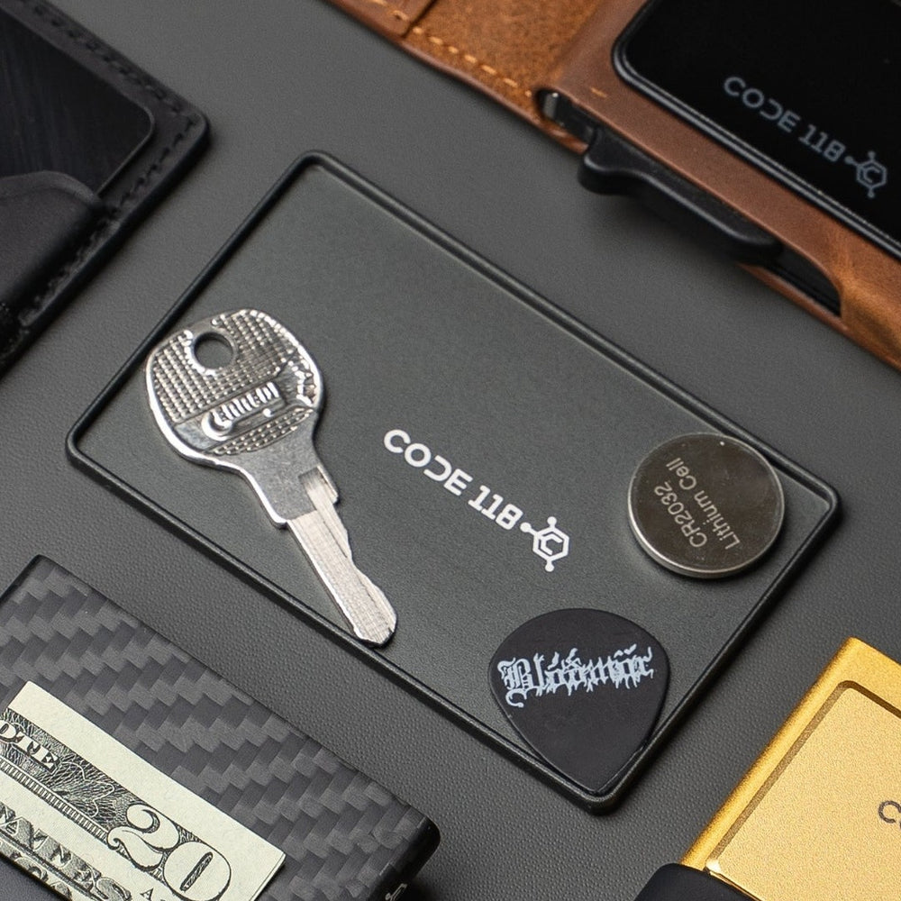 Stash Tray holding a key, a coin battery and a guitar pick
